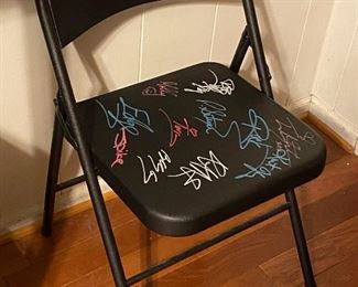 Chair autographed by Duane The Rock Johnson, Kurt Angle, Trish Stratus, both Hardy Boys, Lita, all 3 Dudleys, Molly Holly, Edge, Spike