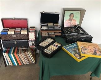 vinyl records, 8 track tapes, cassette tapes, record player