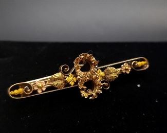 Antique 14k brooch with yellow, green, and pink gold. Two 3/4 carat diamonds were removed from this brooch and could be replaced to make it something special once again.
