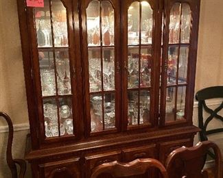 Formal dining room table and matching hutch with glassware