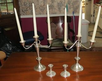 WEIGHTED STERLING CANDELABRA AND CANDLE HOLDERS.