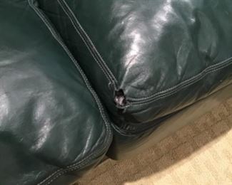 Green leather sofa has some damage