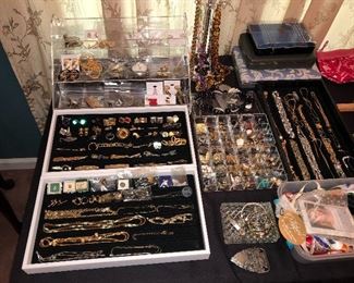 Table full of vintage jewelry