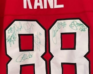 Autographed Kane Jersey -- signed by Patrick Kane, Jonathan Toews, Troy Brouwer and other teammates.
