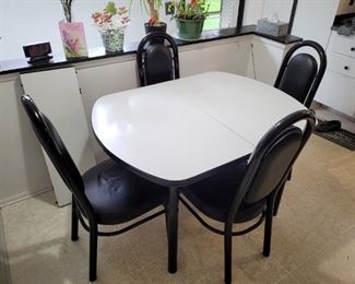 NOW $22!!! Black & white table w/4 chairs and 12" leaf.  All chairs have black duck tape repair