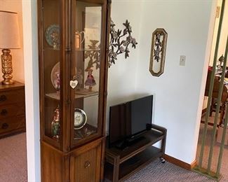 Curio cabinet, television and television stand