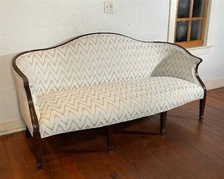CHEVRON UPHOLSTERED SETTEE | Nicely carved mahogany frame with textured off-white colored chevron upholstery; h. 38 x w. 75 x d. 36 in.