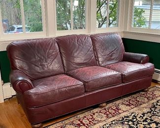 LEATHERCRAFT RED LEATHER COUCH | By Leathercraft Inc., Conover, NC; three seat sofa [leather is worn]; h. 35 x w. 83 x d. 39 in. 
