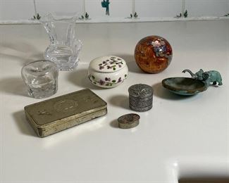 (8pc) MISC. BOXES/DESK ITEMS | Including a GULDENRING ZIGARETTEN cigarette case (2-7/8 x 4-5/8 in.), a Sevres crystal vase [with chips to corners] (h. 4-1/2 in.), an inlaid stone globe paperweight, an elephant vessel, an eagle stamp dispenser, mother of pearl box, and a painted porcelain lidded box 