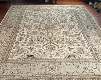 PERSIAN CARPET | 20th century, in excellent condition; having an overall cream colored ground with scrolling acanthus leaves and flourishes throughout, and a tan border; 143 x 107 in. (11 ft. 11 in. x 8 ft. 11 in.) [with some wear] 