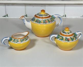 (3pc) ITALIAN TEA SET | Including a teapot, a lidded sugar pot, and an open creamer, all paint-decorated with leafy motif [teapot with chips to spout]; teapot h. 6-1/2 in. 