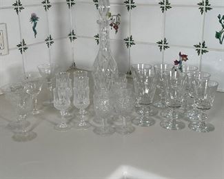 (28pc) MISC. BARWARE | Including a set of 9 small wine glasses, a set of 6 cordial glasses, 4 different cordial glasses, 4 small goblets, and 4 other glasses; plus a decanter [with big chip to stopper] (h. 14 in.) 