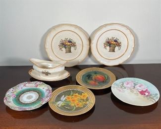 (7pc) MISC. DISHES | Including a three piece set of Old Treriris V&BM fruit basket tableware, with two plates (dia. 10 in.) and a gravy boat [one plate cracked]; two decorative resin/collage plates signed on the back, Scot Poutin (?) 1998; plus two floral decorated and gilt plates 