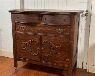 CARVED WOOD BUFFET CABINET | Entry hall/buffet cabinet with two drawers over a full width drawer over double cabinet doors [with loss to applied wood decoration, some cracks to wood]; h. 41 x w. 44 x d. 22 in.