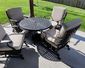 5 Piece patio set with  Leisure Rockers and Table! Elliot Creek Set of 4 New Slate Metal Frame Conversation Chair(s) with Gray Olefin Cushioned Seat Constructed of Alumnicast, featuring heavy-gauge and rust-resistant aluminum-alloy extrusions. Cushions included:) (Pair of chairs sells at Lowes for $438.00 plus tax) Set sells for $1,100 plus tax new! OUR PRICE $600.00
