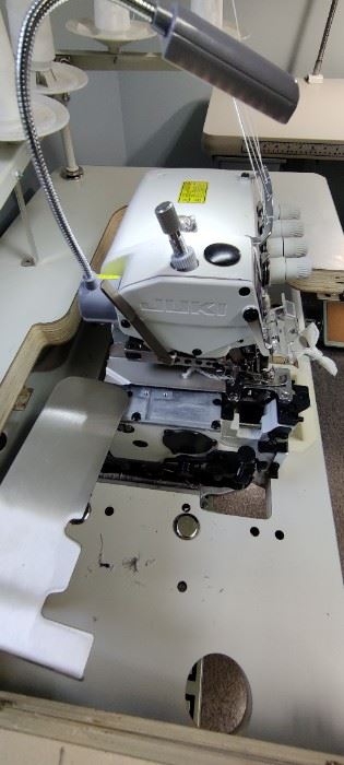 The Juki MO-6814S is Juki’s most popular four-thread serger. It can be used not only as a four-thread serger but also a wide three-thread or narrow three-thread serger. This machine is the most popular serger out there. The 6814S  is widely applicable to the sewing of light-to-medium weight materials. Since the machine is provided with a needle thread take-up mechanism and a looper thread take-up lever, high-quality, well-tensed soft seams are made with a beautiful texture which flexibly correspond to the elasticity of the materials even when run at speeds as high as 7,000 stitches per minute. In addition, the machine has a wider and brighter needle entry and provides improved responsiveness to the materials, thereby helping you use the machine more easily. The optimally-balanced design of the machine reduces both operating noise and vibration, contributing to more comfortable sewing work. Includes commercial table, pedal and upgraded Servo Motor. Sells new at Missouri Sewing Machine C