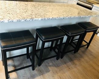 Four black bar stools. Leather seat, black painted legs. $125