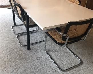 Mid-century formica table with 6 cane seat/back chairs $700