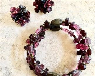 $22 set purple coil bracelet with matching earrings   Adjustable bracelet:  2.5"diam.   Earrings: 1"diam