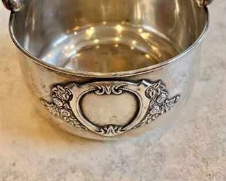 $225  Silver .875 engraved bowl with handle.  5"L; 4"diam 