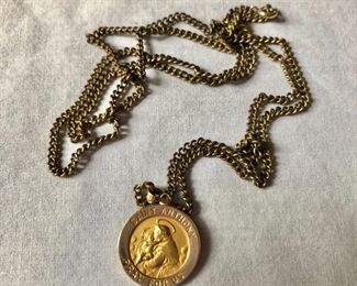 $75 14K Saint Anthony's medallion, chain is gold tone.  Chain:  27".   Pendant:  1"L, 0.8"diam