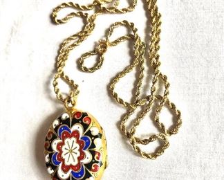 $50 Enamel locket  on gold tone chain.  Chain: 23".  Medallion:  1.5"L, 1"W