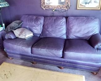 Purple leather couch with nail head detail