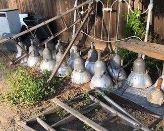 A large selection of arena lights and a beautiful iron headboard.  Think of the bench that headboard would make! Also notice the orchard ladders.