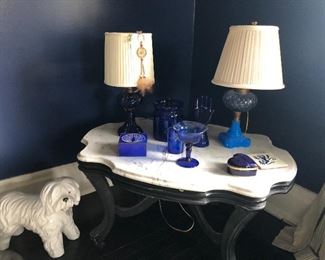 Marble-topped console table and glass lamps, and blue glass decor