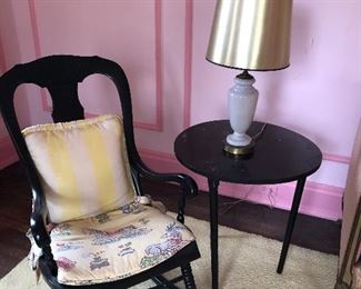 Rocking chair, side table, and lamp with golden shade