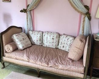 Antique day bed, long kneeling bench or footstool, and brass swag holders on wall 