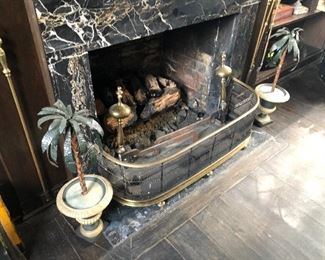 Brass fireplace surround, brass fireplace tools and metal potted plants