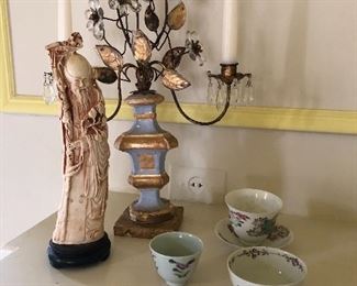 Another view of the brass and porcelain candle holder, Asian tea cups, and carved piece 