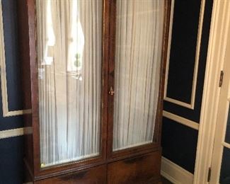 French glass storage cabinet with glass front with sheers and glass shelves with lower drawers