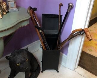 wall mounted console table in vintage green with gold detailing, metal ash box, walking sticks, and black panther in resin 