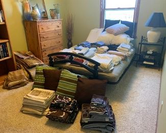 Large amount of bedding - comforters, sheet sets, pillows. 