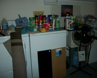 floor fan, wood shelves, rug, cleaning supplies, bags of rags, auto cleaning supplies