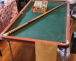 1920s Modern Boy pool table complete with balls, stick, and literature