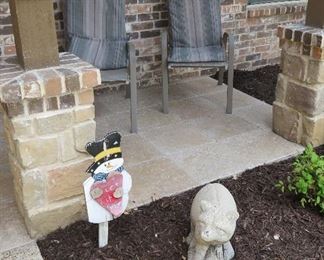 Sling chairs, concrete raccoon garden statue
