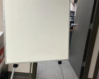 Dry erase board with attached easel - adjustable up to 71 inches in height. Easel board 28X35 $15