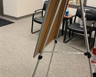 Dry erase board with attached easel - adjustable up to 71 inches in height. Easel board 28X35 $15