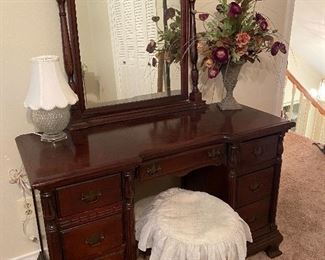 Mahogany vanity , claw foot stool, lamp, arrangement 