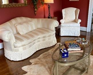 Elegant formal living room furniture with animal skin rug.