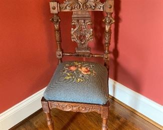 Precious highly carved side chair with needlepoint seat.