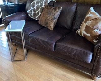 One of two handsome faux leather sofas. Full size