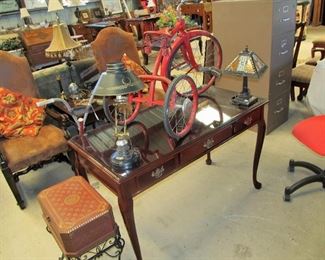 Nice mahogany desk w/ glass top & 1940s tricycle.