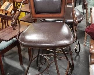 (2) Upscale Wrought Iron Swivel Brown Vinyl With Wood Bar Armchairs (1 chair has a ripped seat in front) $275