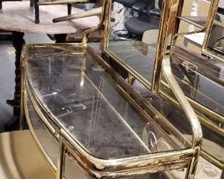 Vintage Brass & Glass Vanity Table With Mirror & Bench    Measures 39 and 3/4 inches long by 15" deep the table itself is 31 and a 1/2 inches tall the mirror from floor to tip is almost 66" tall.  (2 available) $250 ea for choice