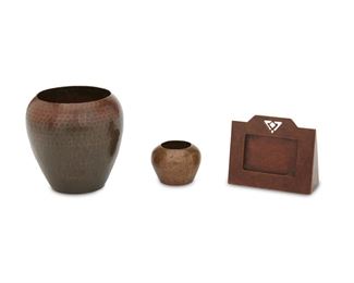 93
Three American Arts And Crafts Copper Table Items
Circa 1913-1938
First signed: Roycroft [late mark]; Second and third signed: Dirk van Erp [open box mark]
Each hand-hammered copper, comprising a tapered vase, a calendar frame with openwork design, and a diminutive bulbous vase, 3 pieces
Largest: 4.5" H x 4.75" Dia.; Smallest: 2.5" Dia.
Estimate: $800 - $1,000