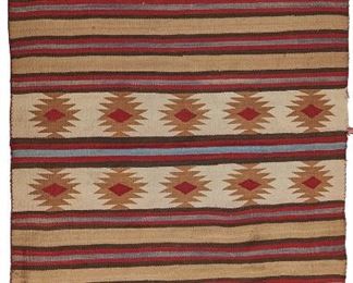 106
A Navajo Regional Rug
Mid-20th Century
Woven of red, cream, tan, dark brown, and blue in a banded motif with four sections of tan and red serrated stars
62" L x 39.5" W
Estimate: $400 - $600